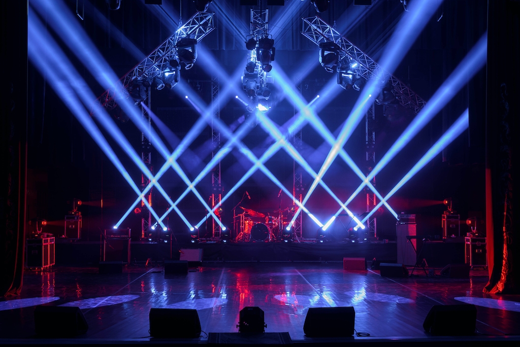 Lights crisscrossing on an empty stage